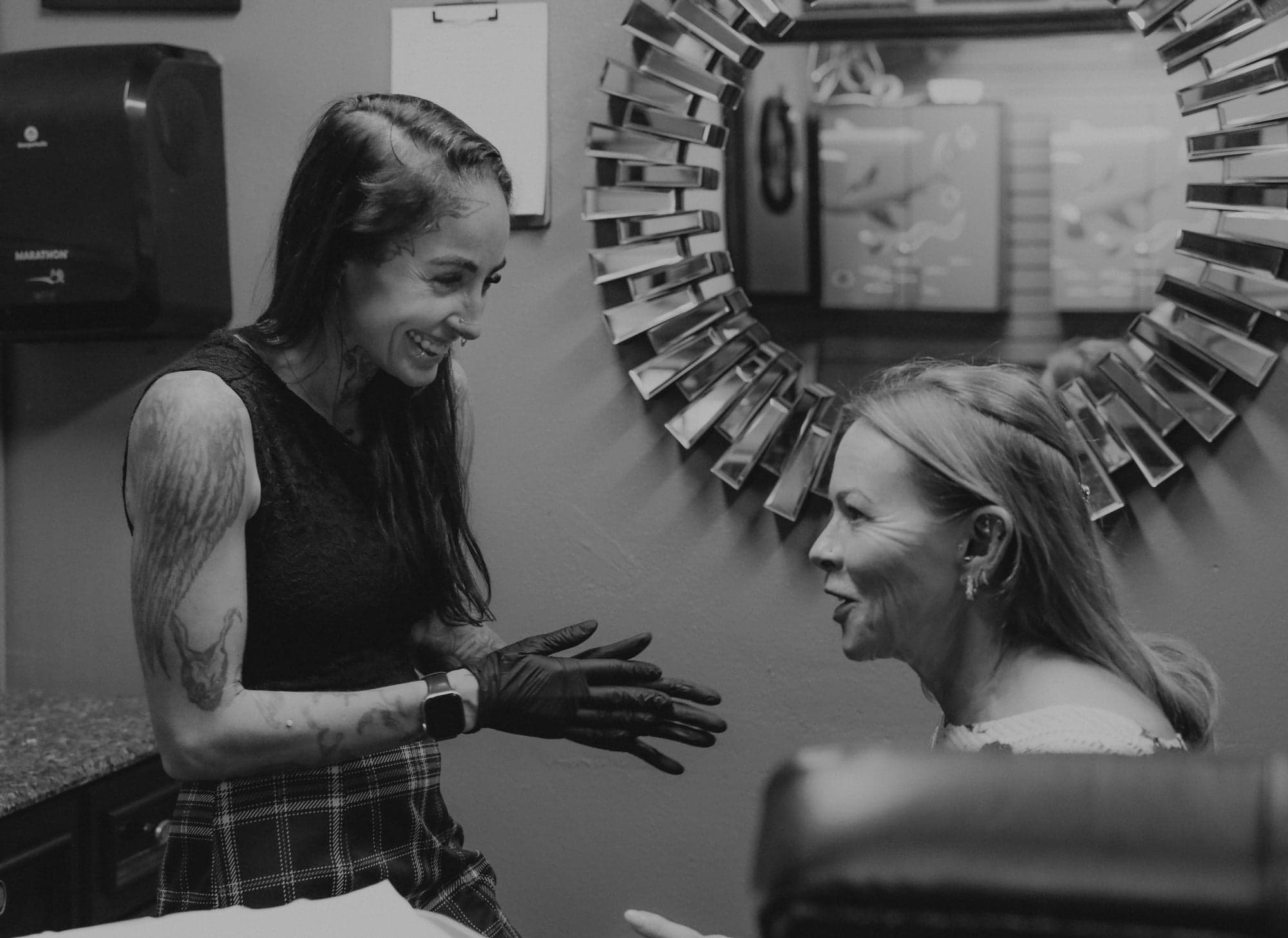 A piercer talking with a client before a piercing